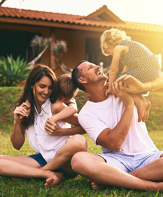 Family of four sitting in their front yard